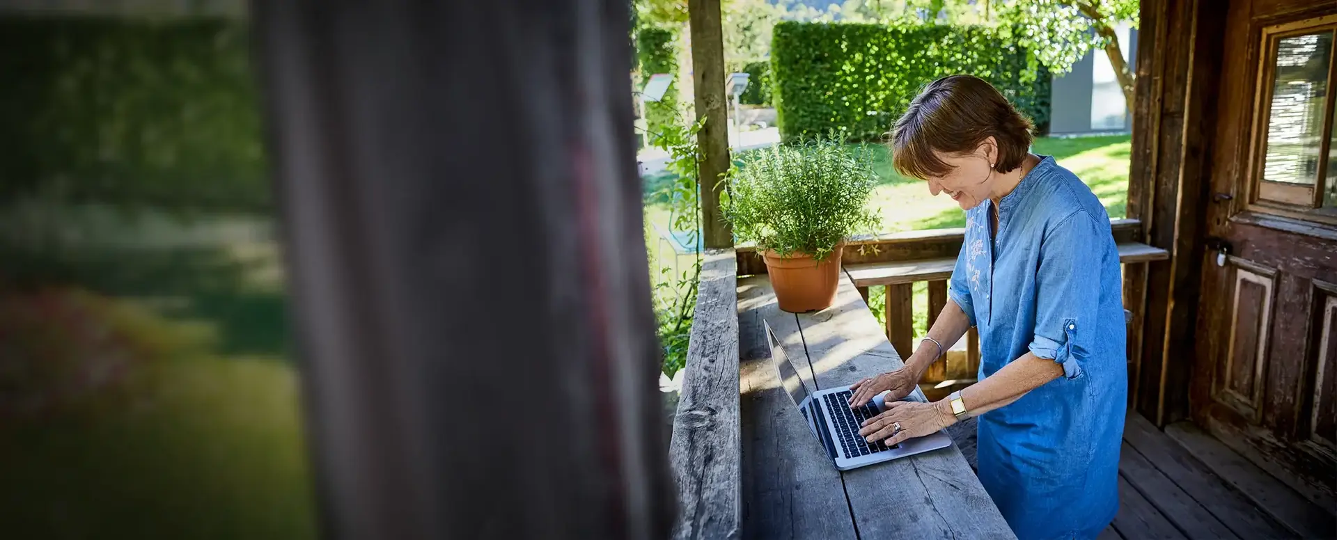 Woman working on laptop outdoors